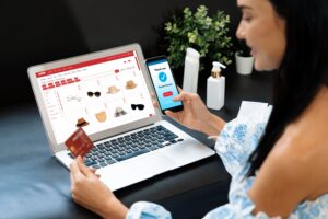 Young woman order or purchase product on internet using laptop and make transaction payment by smartphone. Online shopping lifestyle with credit card via internet banking on mobile application. Blithe