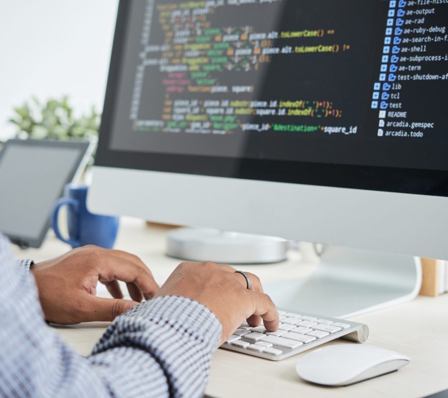 Cropped image of It specialist working on code